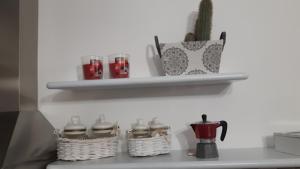 a kitchen counter with two baskets and a cactus on a shelf at Little house in Alghero
