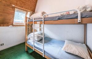 two bunk beds in a room with a window at Residence L'Aiguille - maeva Home in Chamonix-Mont-Blanc