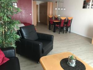 a living room with a couch and chairs and a table at Steiner Strandappartements Appartement 305 Seeseite in Stein +2 photos