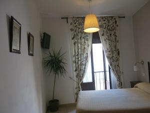 Postel nebo postele na pokoji v ubytování Hostal Fenix