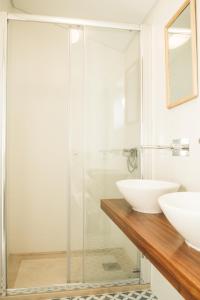 a bathroom with a glass shower and a sink at Apartamento 2 quartos by WOT Ericeira Lodge in Ericeira
