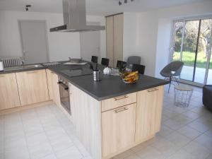 a kitchen with a counter with a bowl of fruit on it at Gîtes de Botplançon in Saint-Aignan