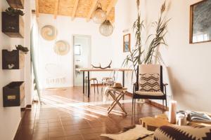 a living room with a table and chairs at Apartamento 2 quartos by WOT Ericeira Lodge in Ericeira