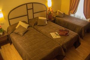 Postel nebo postele na pokoji v ubytování Hotel Novecento