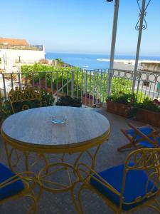 a table and chairs with a view of the ocean at Hotel Villa Delle Palme in Positano in Positano