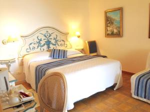a bedroom with a large white bed in a room at Hotel Villa Delle Palme in Positano in Positano