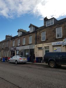 a truck parked on the side of a street at 89 Clerk Street in Loanhead