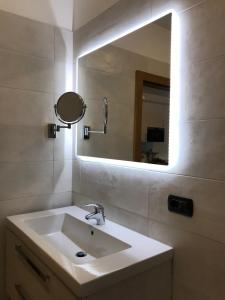 a bathroom with a sink and a mirror at Casa Chiara in Riva del Garda