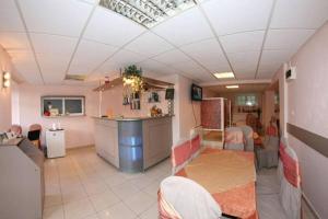 a room with a kitchen with a counter and a bar at Gura Padurii in Sinaia