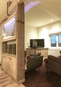 a living room with a large aquarium and a couch at Manhattan loft in Margate