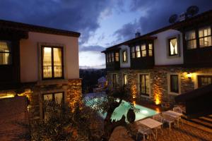 a house with a swimming pool at night at Akanthus Hotel Ephesus in Selcuk