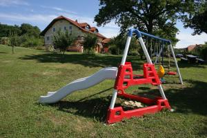 a playground with a slide in the grass at Panorama B&B in Ptuj +39 photos