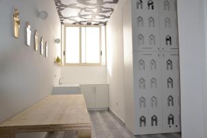 a dining room with a table and a window at La Giara in Torre Lapillo