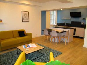 a living room with a couch and a table at Carnot Chic in Carcassonne