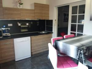 a kitchen with a table and pink chairs in it at cavaliere studio 2 pers in Le Lavandou