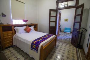 a bedroom with a bed and a window and a door at Casa Meba Hotel Boutique in Tampico +22 photos
