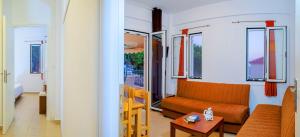 a living room with a couch and a table at Romanos Beach Villas in Romanu
