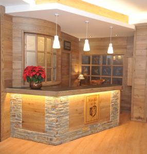 a bar in a room with wooden walls at Hotel Lacreu in Salardú