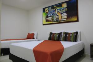 Tempat tidur dalam kamar di Hotel Pereira 421