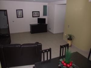 a living room with a table and a couch at MR Hotel in San Pedro Jácuaro