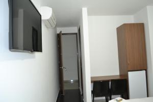 a room with a flat screen tv on a wall at Hotel Grand Premium Plaza in Pitalito