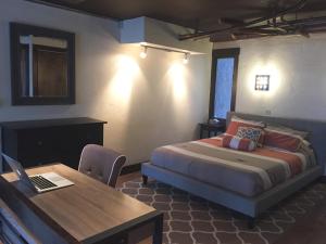 a bedroom with a bed and a table with a laptop at Vail View Loft - Slope-view condo, free bus for quick access to Vail Village in Vail