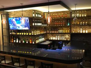 a bar with a flat screen tv above it at Hotel Real San Javier in San Juan de los Lagos
