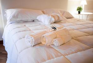A bed or beds in a room at La Casa di Ilde al Duomo - Ortigia Holidays