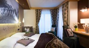 Voodi või voodid majutusasutuse Hotel Chalet Sas Morin toas