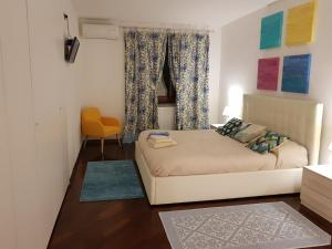 a living room with a bed and a chair at La Casa Degli Ospiti in Naples