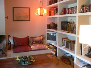 a living room with a couch and a tv at Can Seuba in Rellinars