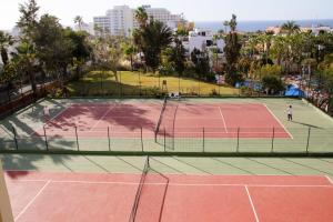 two people playing tennis on a tennis court at Las Americas Tenerife in Playa de las Americas