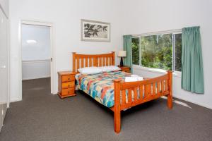 
A bed or beds in a room at Kioloa Beach Holiday Park
