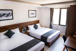 Uma cama ou camas num quarto em Robin Hotel Danang