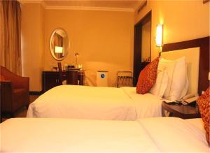 Ένα ή περισσότερα κρεβάτια σε δωμάτιο στο Jinjiang Fuyuan Hotel