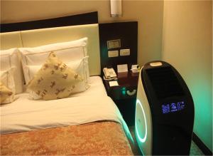 Ένα ή περισσότερα κρεβάτια σε δωμάτιο στο Jinjiang Fuyuan Hotel