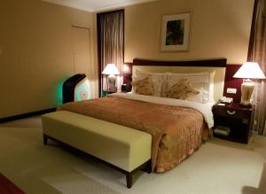 Ένα ή περισσότερα κρεβάτια σε δωμάτιο στο Jinjiang Fuyuan Hotel