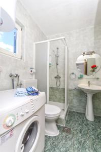 a bathroom with a washing machine and a sink at Apartment Branka in Srima