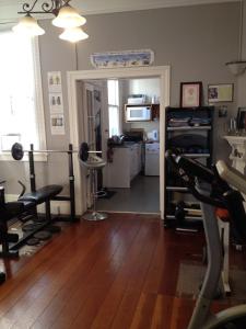 a living room with a gym with a treadmill at Ponsonby Boutique Villa with Private Gym in Auckland
