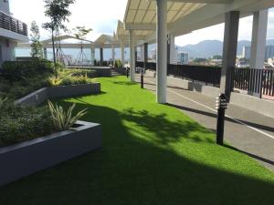 a green lawn on the roof of a building at PM Octagon Ipoh Suites & Apartment 2 in Ipoh
