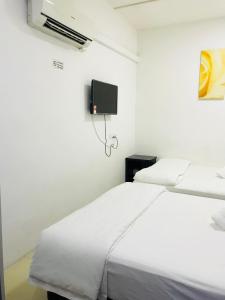 Postel nebo postele na pokoji v ubytování H-Hotel