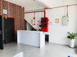 a kitchen with a red appliance in a room at H-Hotel in Johor Bahru
