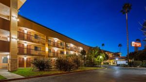 an exterior view of a hotel at night at Best Western Plus Pleasanton Inn in Pleasanton