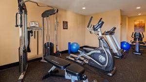 a gym with several exercise equipment in a room at Best Western Plus Pleasanton Inn in Pleasanton