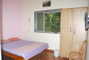 Postel nebo postele na pokoji v ubytování Hotel Anjali Lodge Malvan
