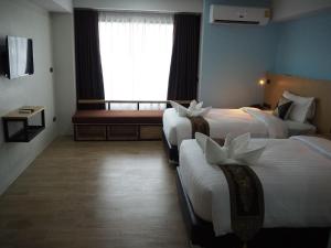 Postel nebo postele na pokoji v ubytování Samui City Hotel