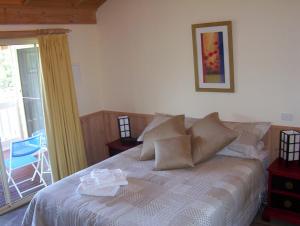 a bedroom with a bed and a sliding glass door at Yarra Glen Bed & Breakfast in Yarra Glen