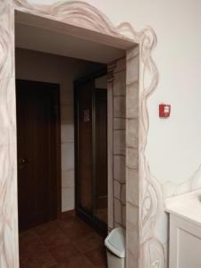 a bathroom with a toilet and a door in it at Aparthotel NA DOBU in Lviv
