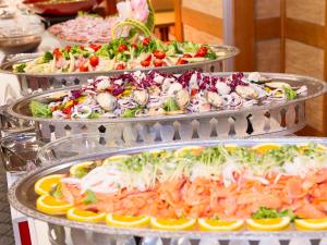 three trays of different types of food on a table at Itoen Hotel Toi in Izu