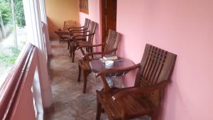 a row of chairs and a table in a room at Jaya Home Stay in Tangalle